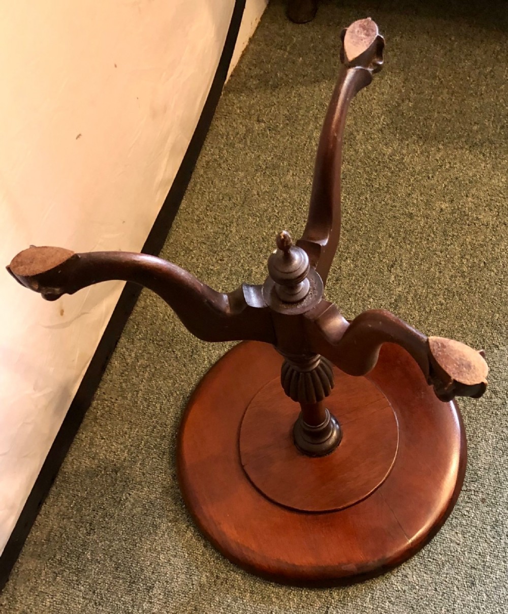 A small early twentieth-century mahogany tripod wine table featuring a circular top with a beaded rim, turned stem, and three cabriole legs. View V