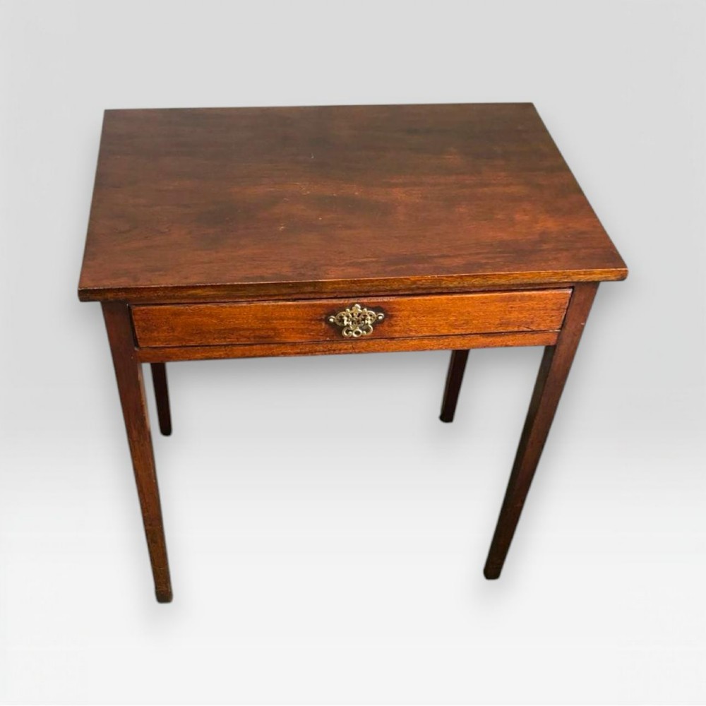 A small George III mahogany side table featuring a single frieze drawer, brass backplate handle, and four straight legs.