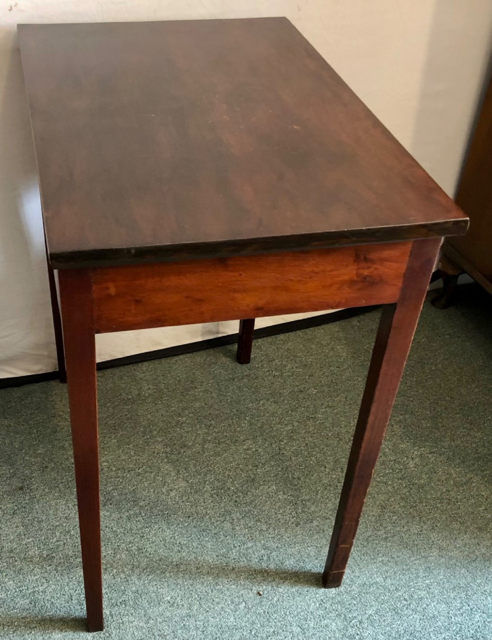 A small George III mahogany side table featuring a single frieze drawer, brass backplate handle, and four straight legs. View VI