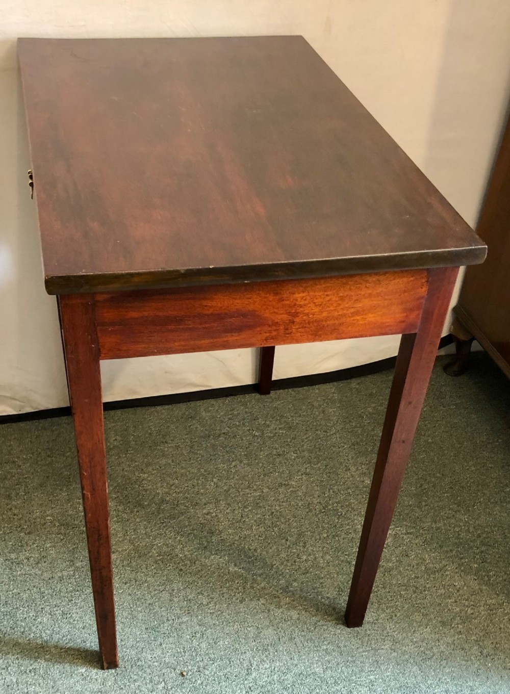 A small George III mahogany side table featuring a single frieze drawer, brass backplate handle, and four straight legs. View VII