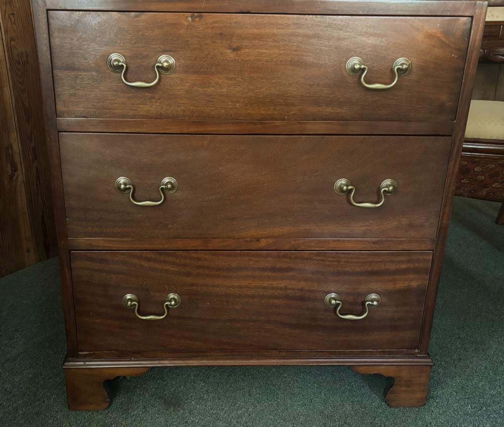 An early 20th century mahogany tallboy chest featuring six graduated drawers with brass drop handles and bracket feet. View VIII