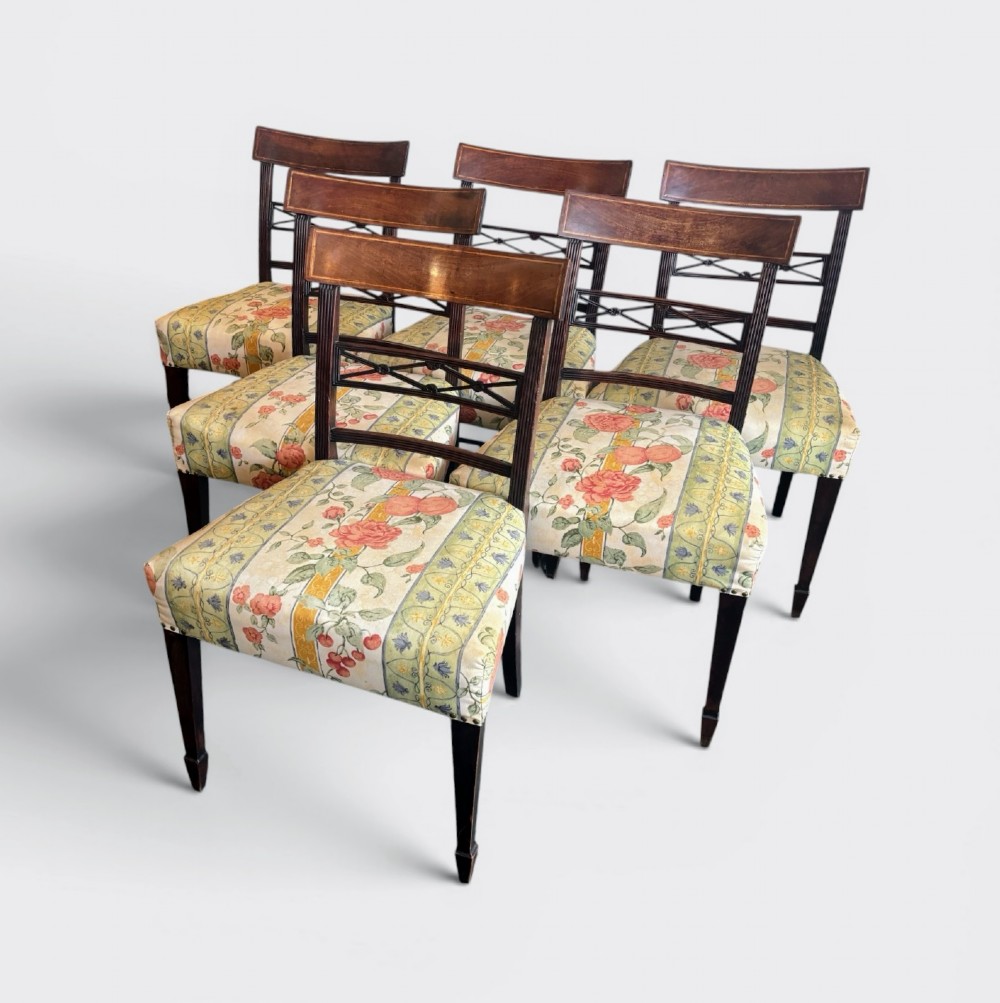 A set of six early nineteenth century mahogany dining chairs featuring tablet top rails, reeded frames, lattice splats, and floral striped fabric seats. View II