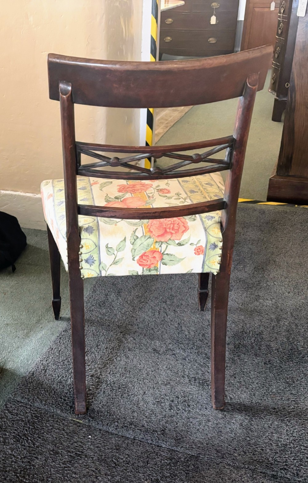 A set of six early nineteenth century mahogany dining chairs featuring tablet top rails, reeded frames, lattice splats, and floral striped fabric seats. View IV