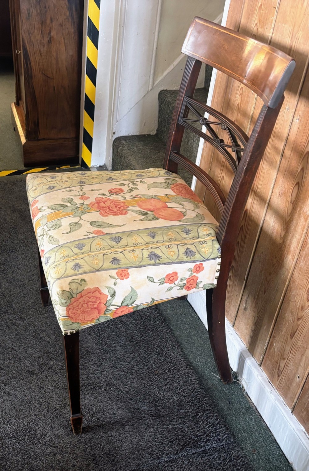 A set of six early nineteenth century mahogany dining chairs featuring tablet top rails, reeded frames, lattice splats, and floral striped fabric seats. View V