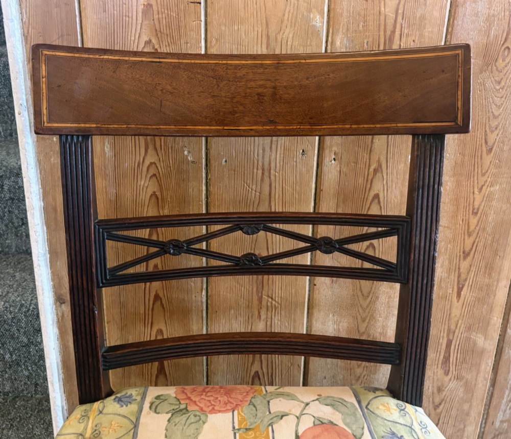 A set of six early nineteenth century mahogany dining chairs featuring tablet top rails, reeded frames, lattice splats, and floral striped fabric seats. View VI