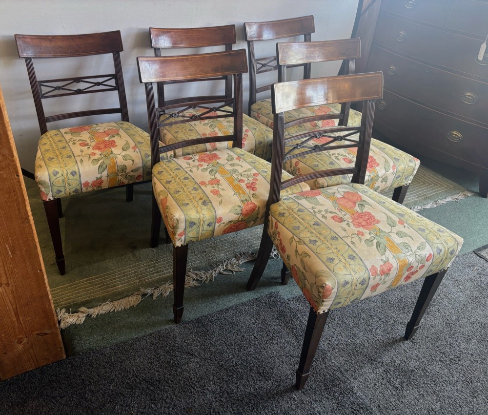 A set of six early nineteenth century mahogany dining chairs featuring tablet top rails, reeded frames, lattice splats, and floral striped fabric seats. View VIII
