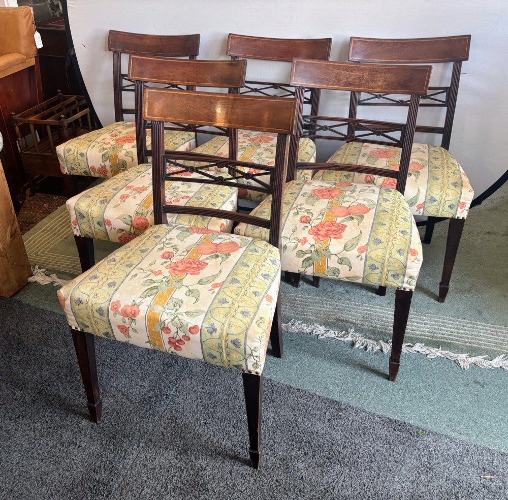A set of six early nineteenth century mahogany dining chairs featuring tablet top rails, reeded frames, lattice splats, and floral striped fabric seats. View IX