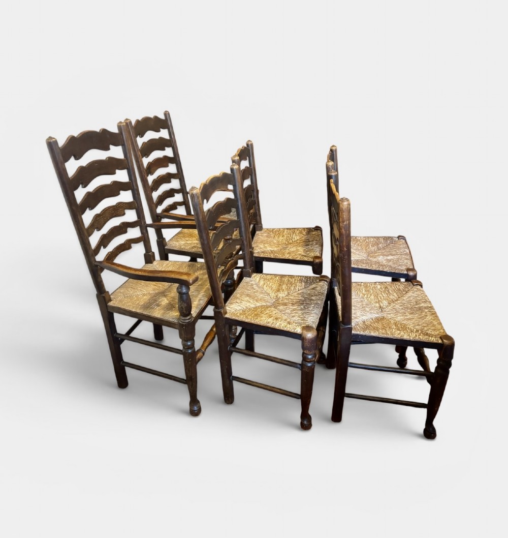 A set of dark oak ladder back chairs featuring woven rush seats and turned front legs. View III