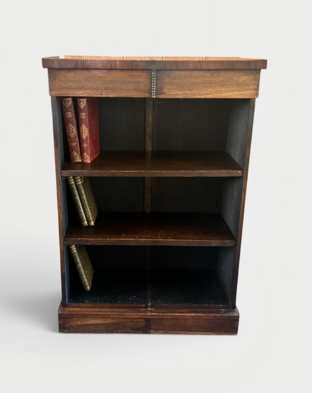 A small 19th-century rosewood open bookcase featuring three internal storage shelves and a solid plinth base.