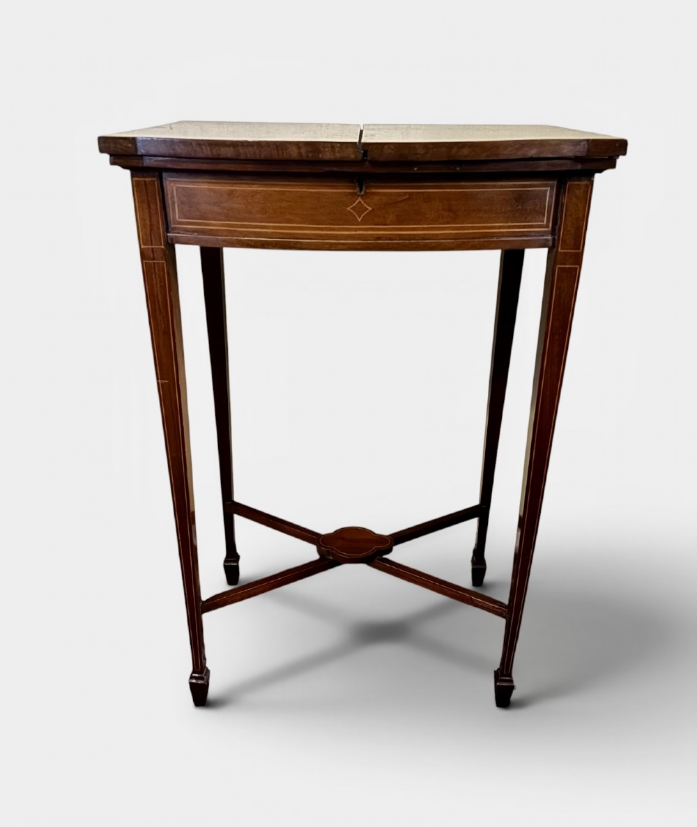 A small Edwardian mahogany work table featuring dual hinged top flaps with delicate satinwood inlay, tapered legs, and an X-frame stretcher. View II