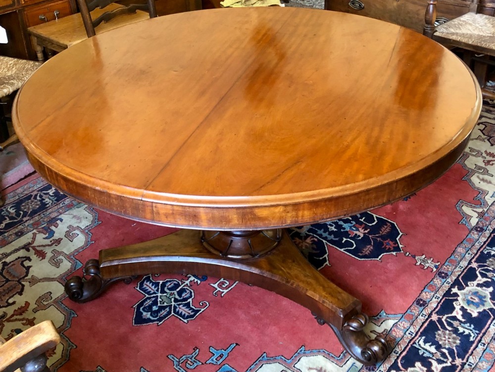 Large Regency figured mahogany tilt top round dining table View II