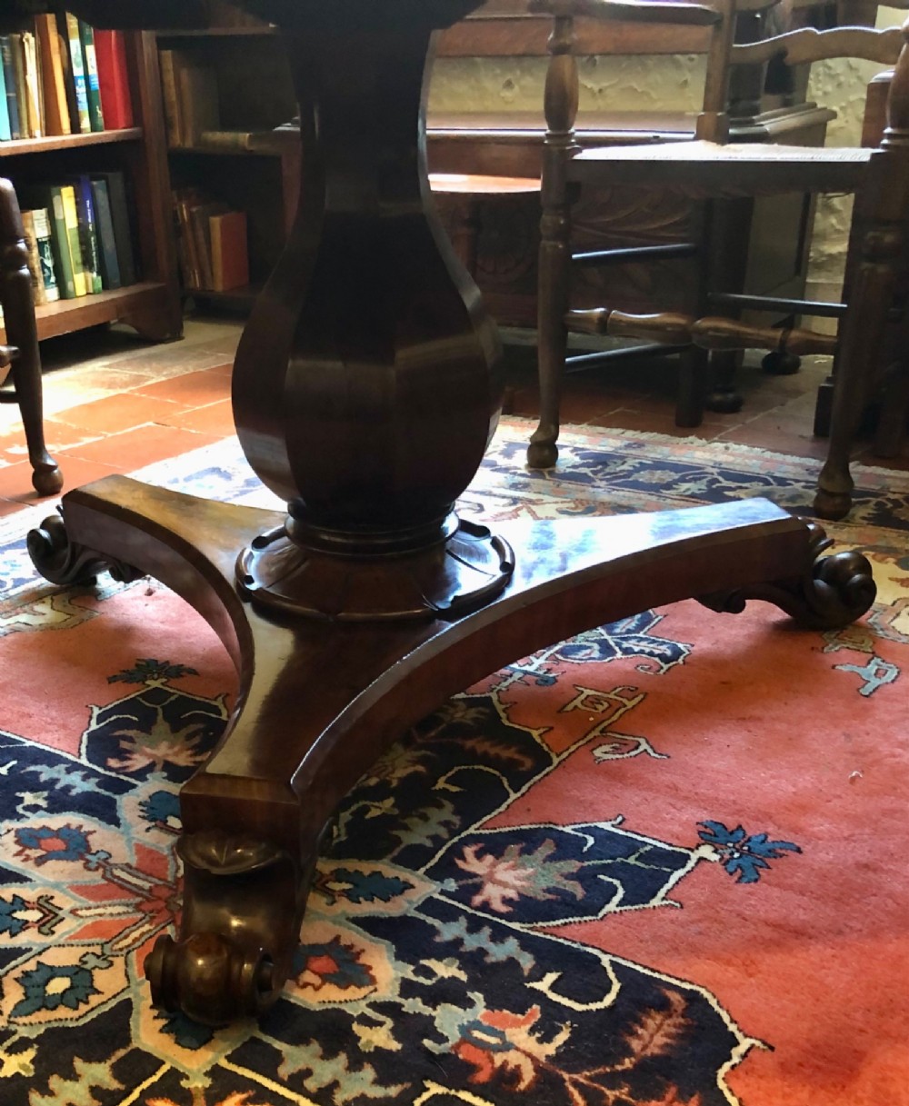 Large Regency figured mahogany tilt top round dining table View VII