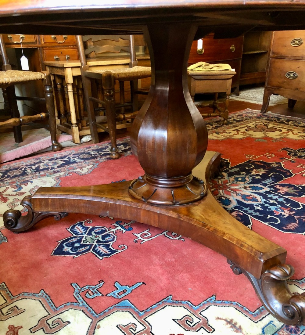 Large Regency figured mahogany tilt top round dining table View VIII