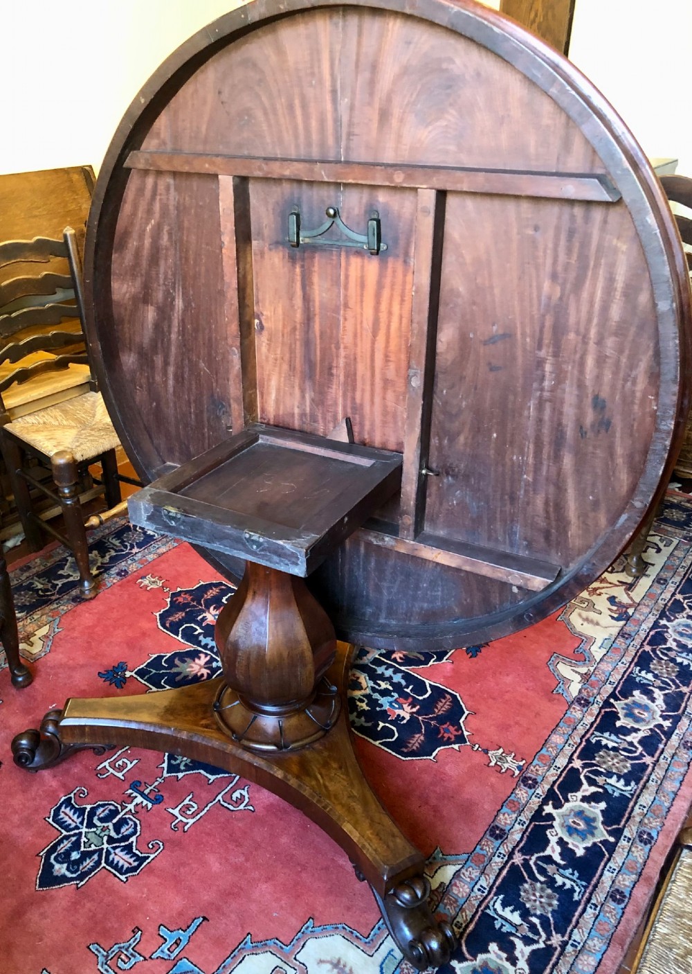 Large Regency figured mahogany tilt top round dining table View X