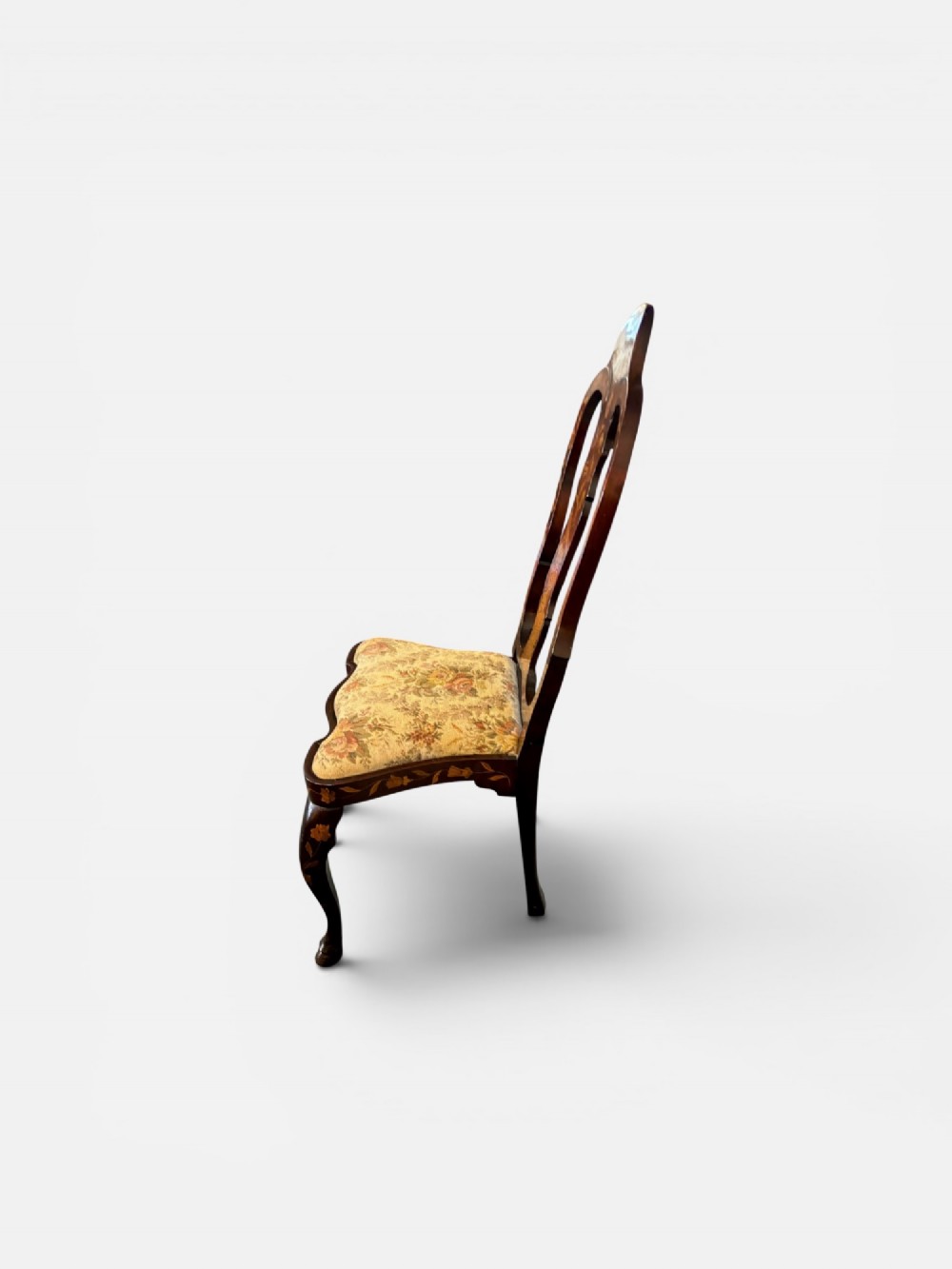 An antique Dutch walnut side chair featuring detailed floral marquetry inlay across the vase splat, apron, and cabriole legs, fitted with a floral fabric drop-in seat. View III