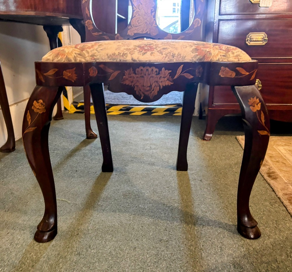 An antique Dutch walnut side chair featuring detailed floral marquetry inlay across the vase splat, apron, and cabriole legs, fitted with a floral fabric drop-in seat. View VII