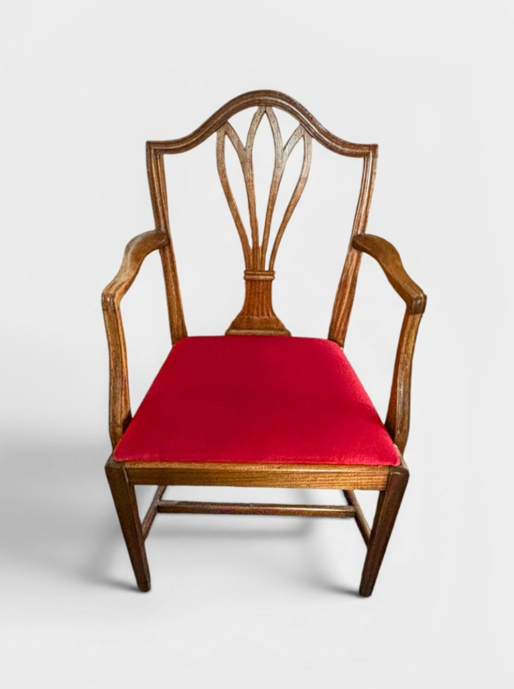 A set of eight George III mahogany dining chairs featuring carved wheat sheaf back splats and red velvet seats. View VI