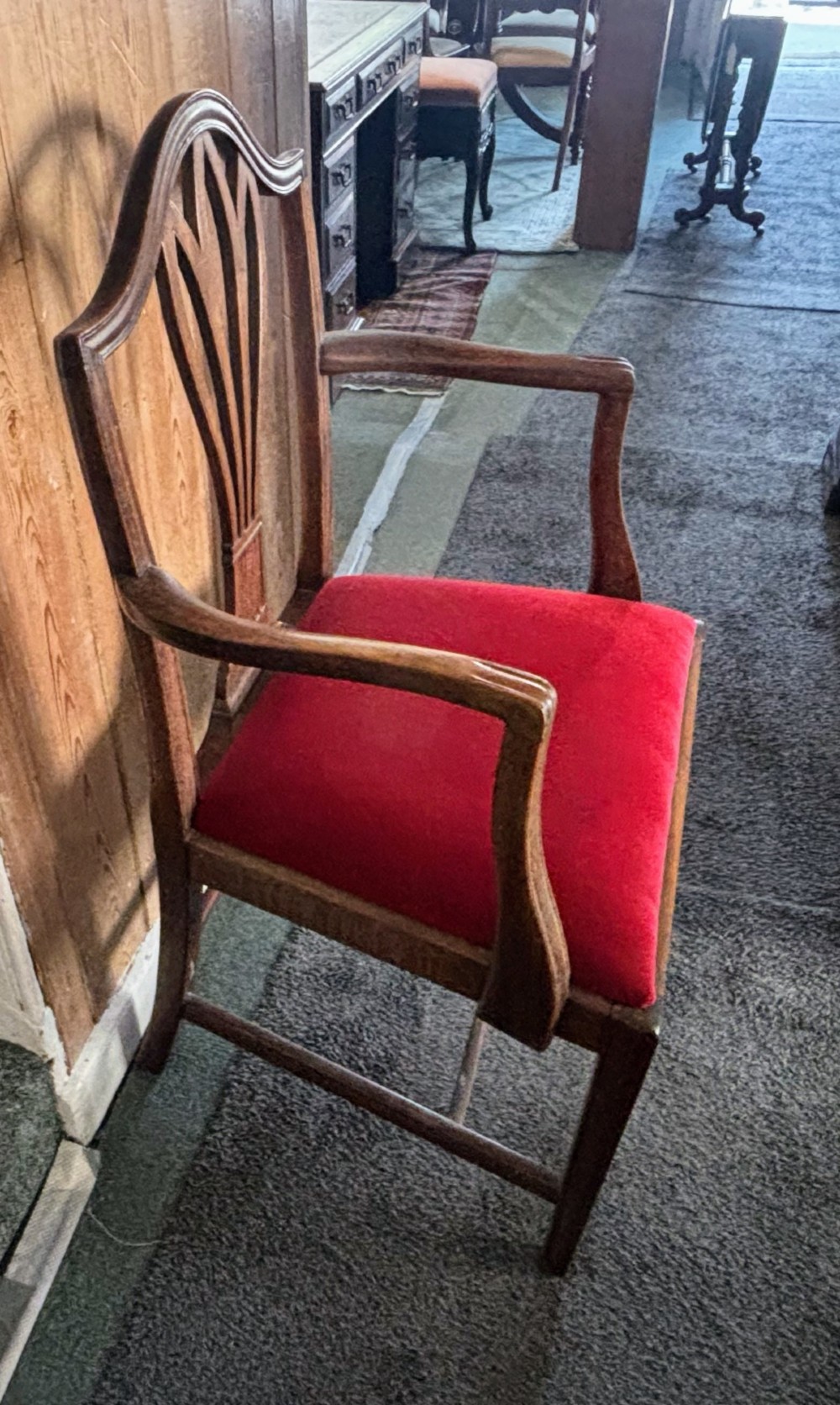 A set of eight George III mahogany dining chairs featuring carved wheat sheaf back splats and red velvet seats. View VIII