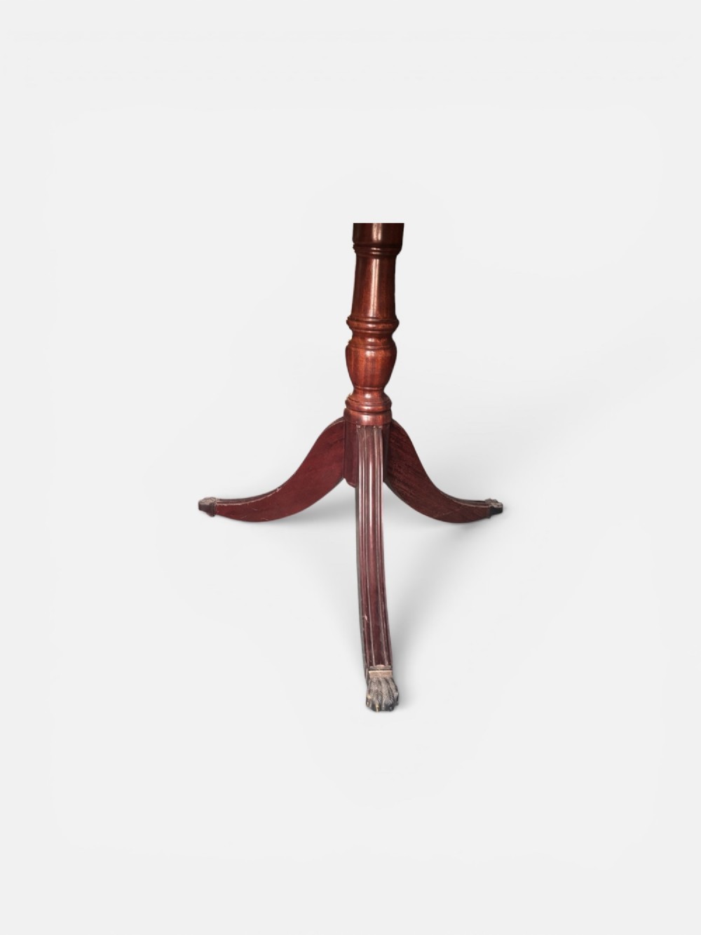 A Regency style mahogany twin pillar dining table featuring a crossbanded top and splayed quadruped feet on brass castors. View III
