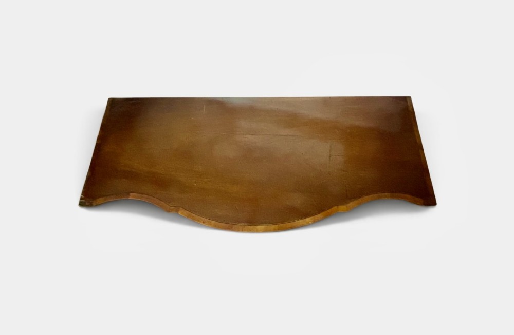 A George III mahogany serpentine-front sideboard featuring circular inlaid drawer details, brass ring handles, and square tapered legs. View II
