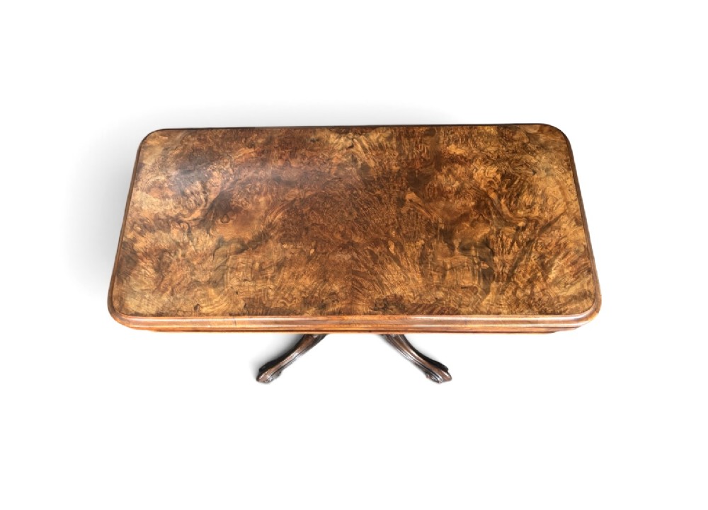 A Victorian rectangular flip-top card table made from figured walnut wood, featuring rounded corners and a carved quad-form pedestal base. View II
