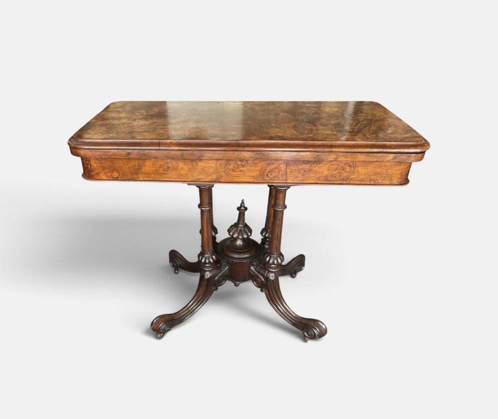 A Victorian rectangular flip-top card table made from figured walnut wood, featuring rounded corners and a carved quad-form pedestal base. View III