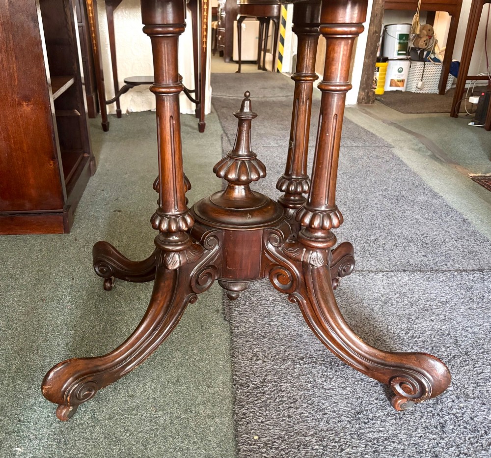 A Victorian rectangular flip-top card table made from figured walnut wood, featuring rounded corners and a carved quad-form pedestal base. View VII