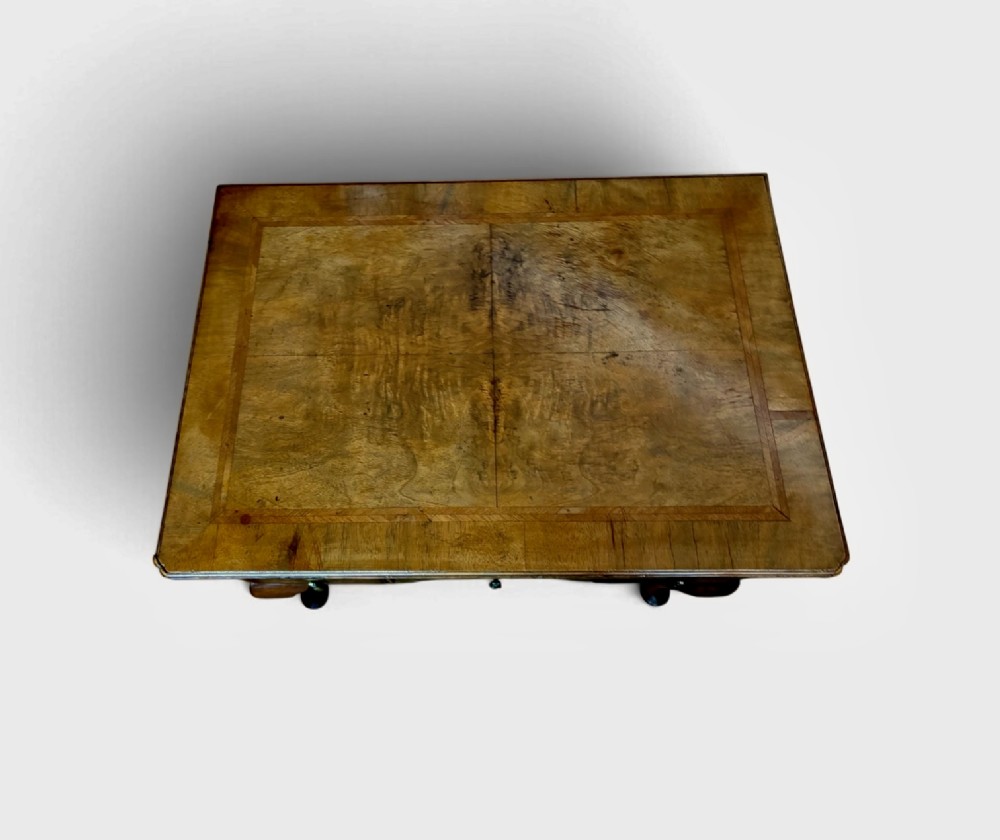 A Georgian style burr walnut lowboy featuring three drawers with brass drop handles, a shaped apron, and cabriole legs. View II
