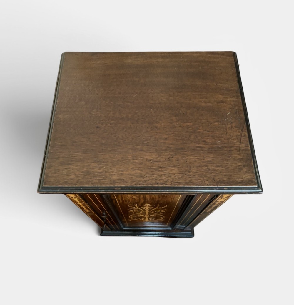 A narrow Victorian dark rosewood single-door cabinet featuring detailed satinwood floral and urn marquetry inlay. View II