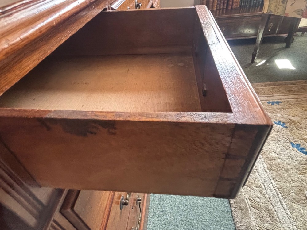 A Victorian mahogany pedestal desk featuring an inset green leather writing surface and nine drawers with brass drop handles. View VI