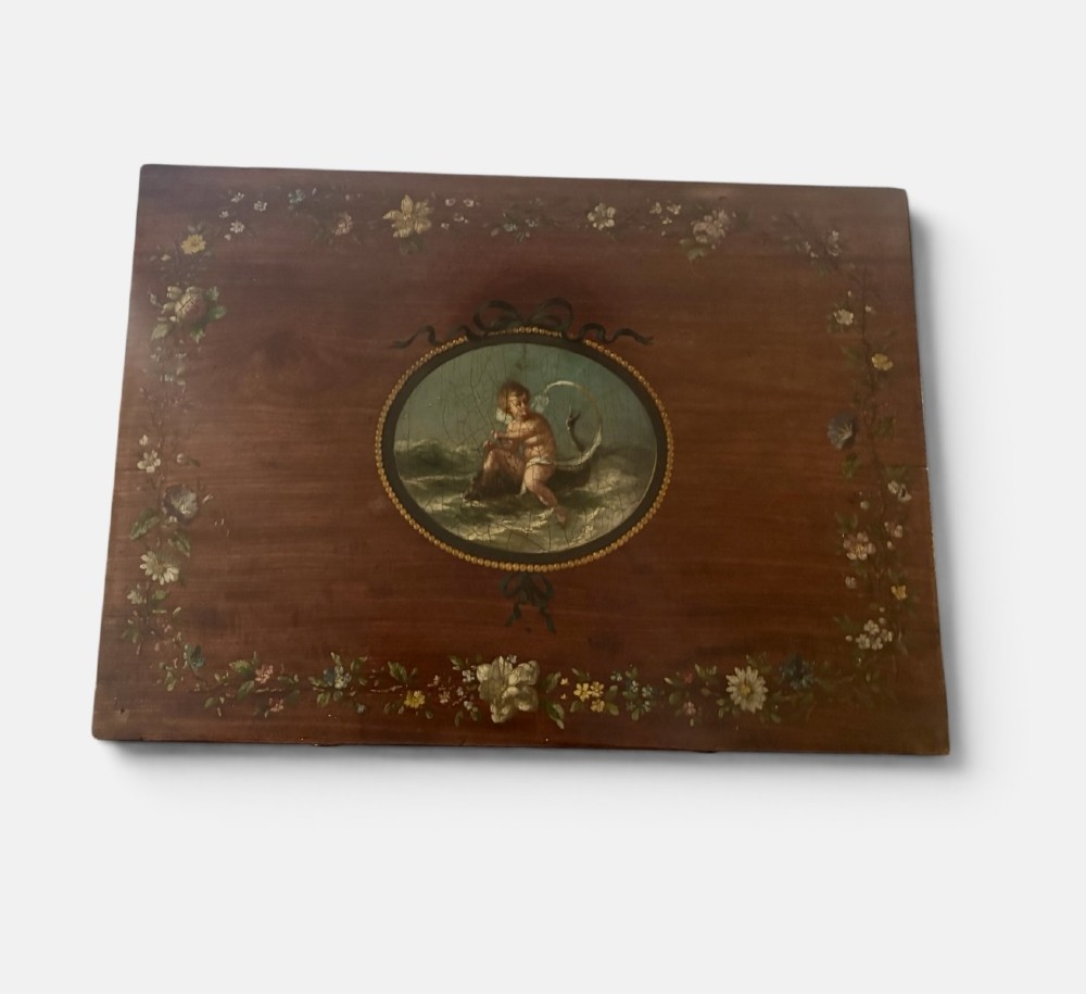 An early Victorian mahogany side table featuring hand-painted floral garlands across the surface and drawer, supported by trestle legs and a turned central stretcher. View VI