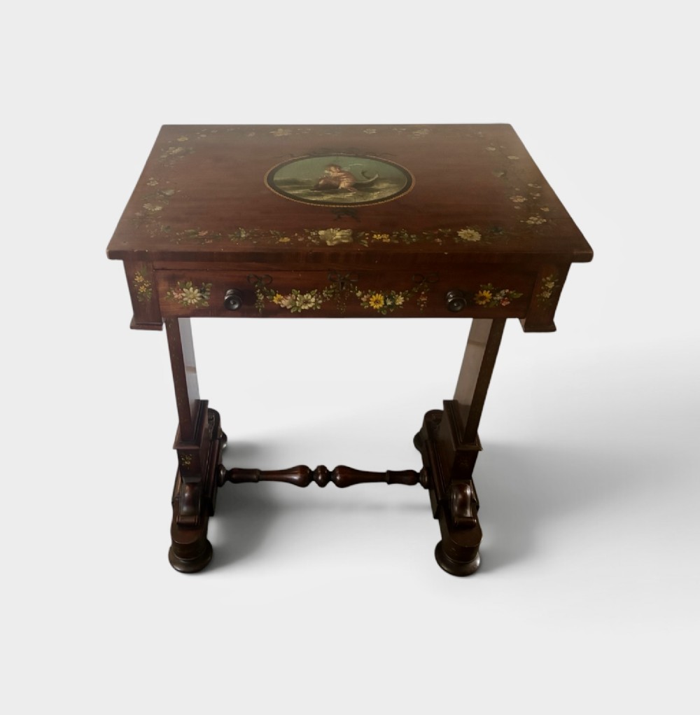 An early Victorian mahogany side table featuring hand-painted floral garlands across the surface and drawer, supported by trestle legs and a turned central stretcher. View VII