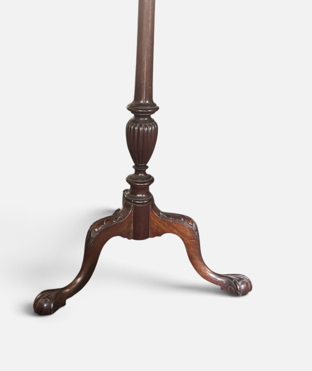 A small mahogany tripod table featuring a raised scalloped piecrust top supported by a carved central pedestal and three cabriole legs. View IV
