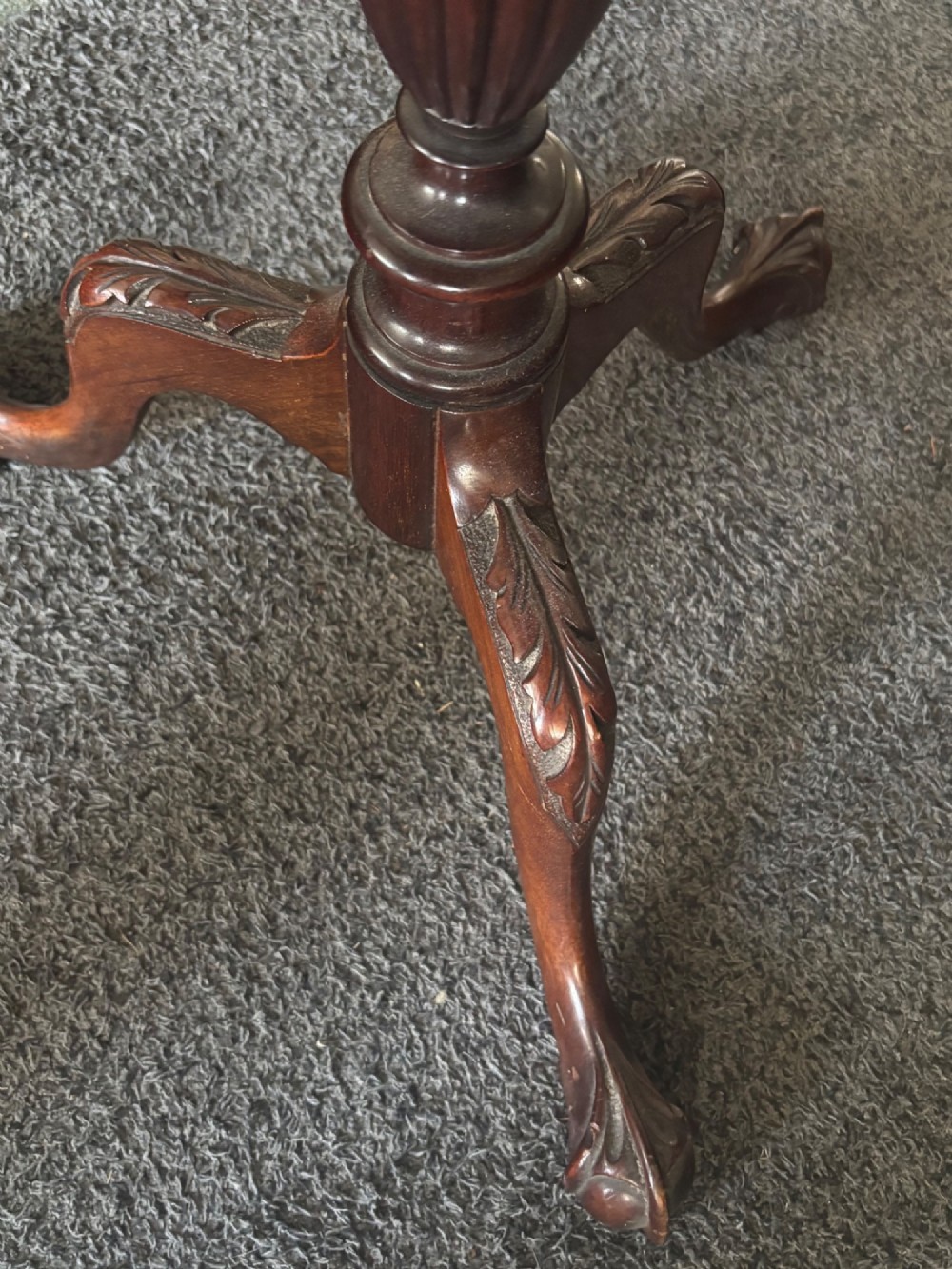 A small mahogany tripod table featuring a raised scalloped piecrust top supported by a carved central pedestal and three cabriole legs. View VI