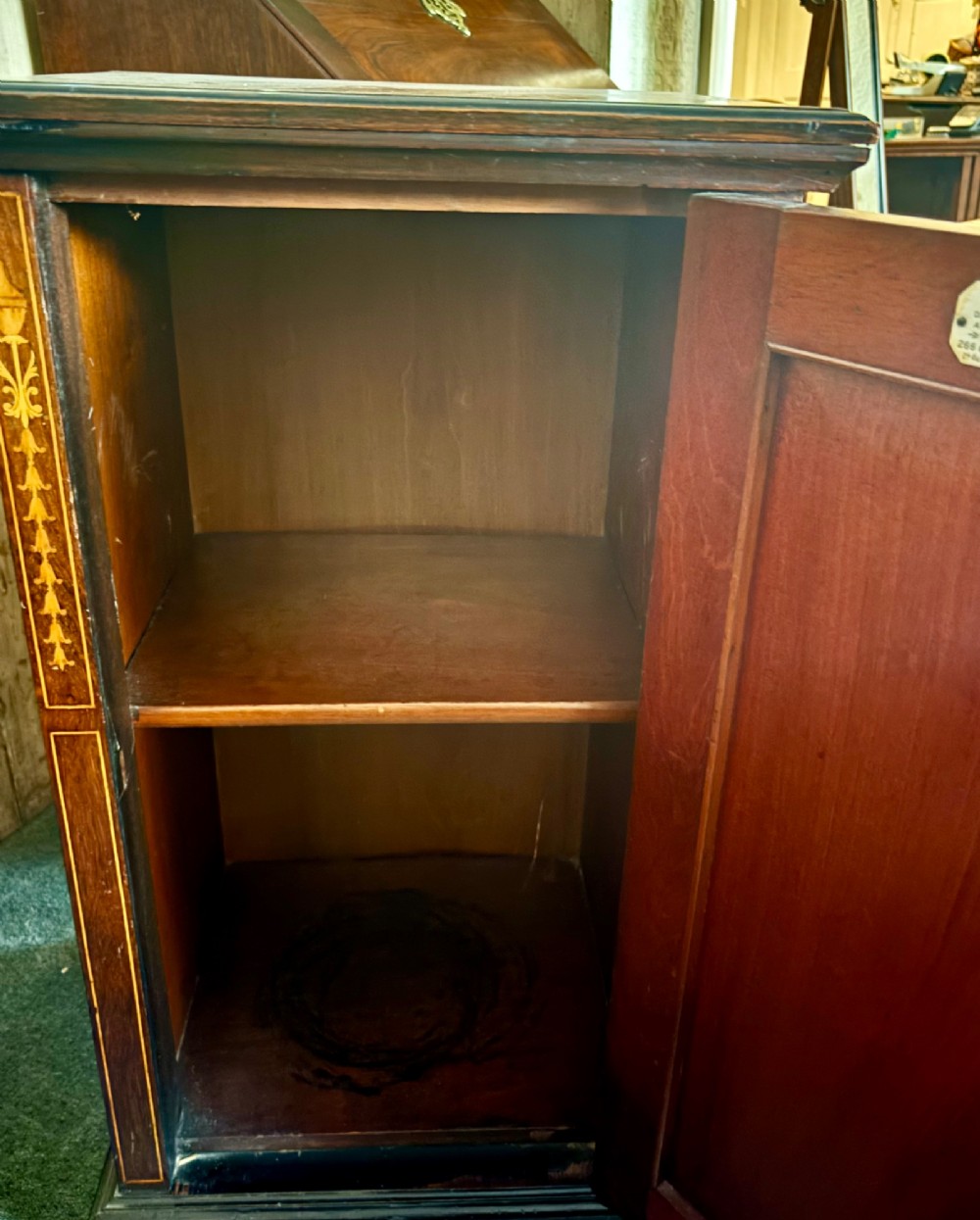 A tall, narrow Victorian rosewood cabinet featuring intricate floral marquetry inlay on the single panelled door and side pilasters. View VI