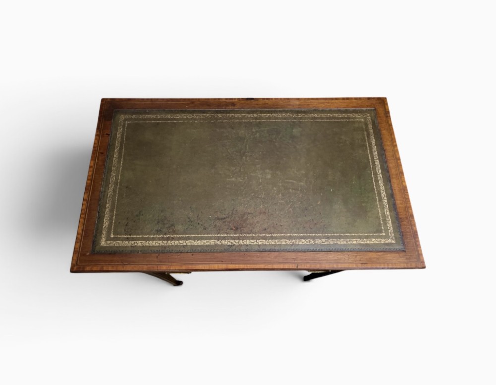 An Edwardian mahogany writing table featuring a green leather insert surface, satinwood crossbanding, one long drawer, and square tapered legs. View II