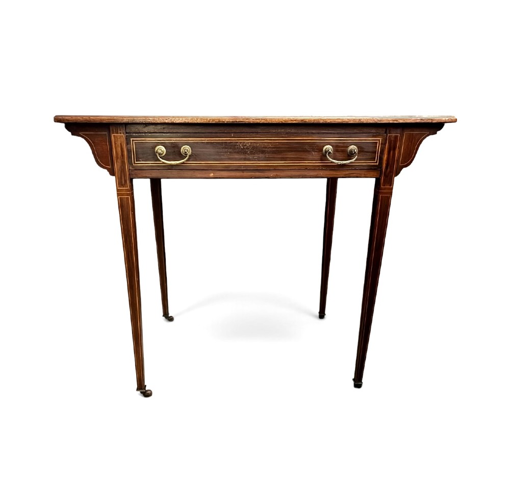An Edwardian mahogany writing table featuring a green leather insert surface, satinwood crossbanding, one long drawer, and square tapered legs. View III
