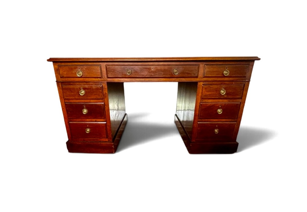 A large Edwardian mahogany pedestal desk featuring nine drawers with circular brass ring handles and a flat plinth base. View II