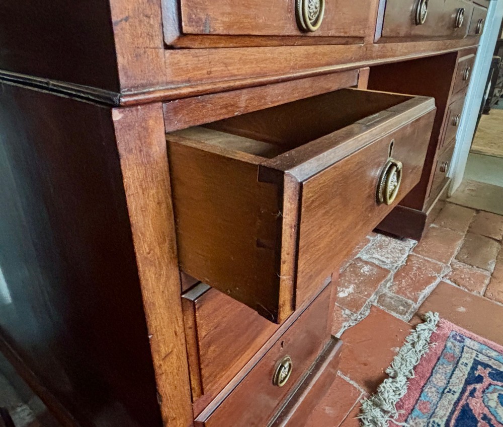 A large Edwardian mahogany pedestal desk featuring nine drawers with circular brass ring handles and a flat plinth base. View VI