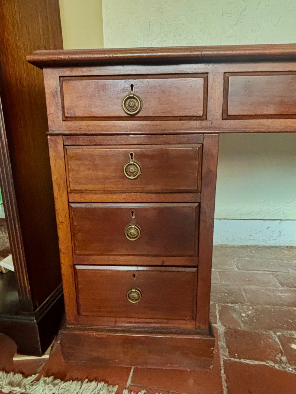 A large Edwardian mahogany pedestal desk featuring nine drawers with circular brass ring handles and a flat plinth base. View VIII