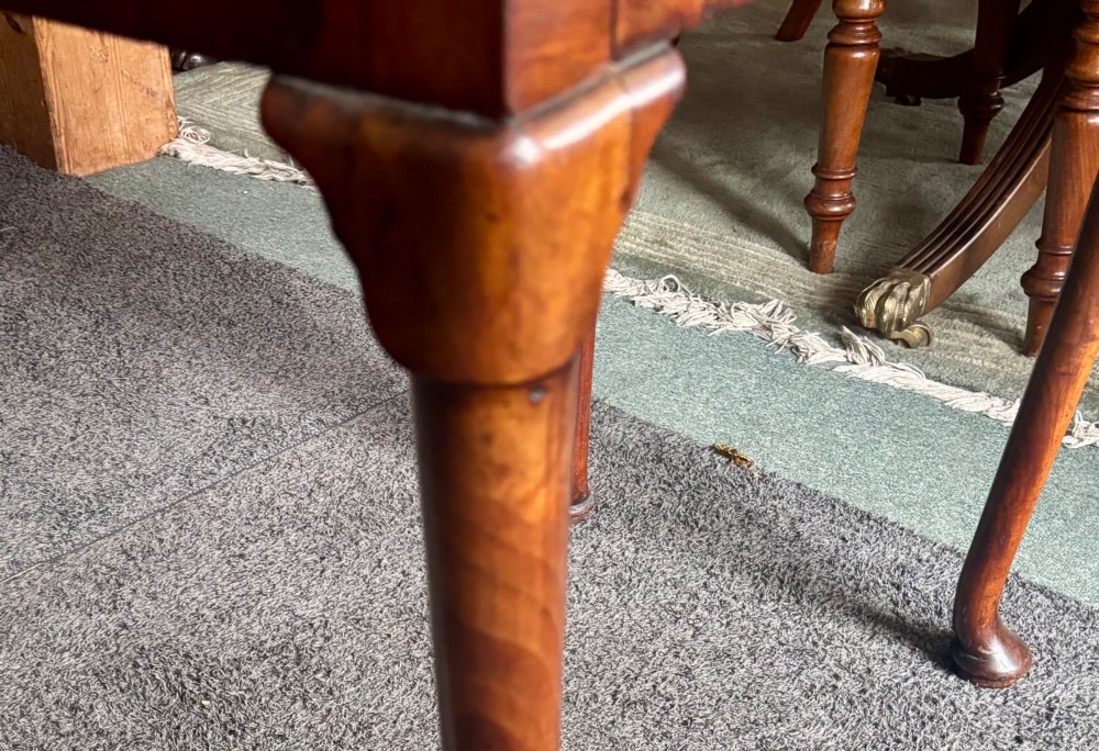 A George III walnut lowboy featuring a crossbanded top, a drawer with brass handles, and slender cabriole legs terminating in pad feet. View VII