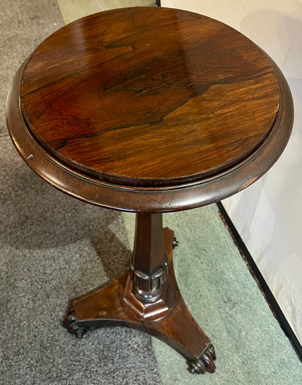 An early 19th-century rosewood wine table featuring a circular top, a tapered column, and a triform base with carved feet. View III