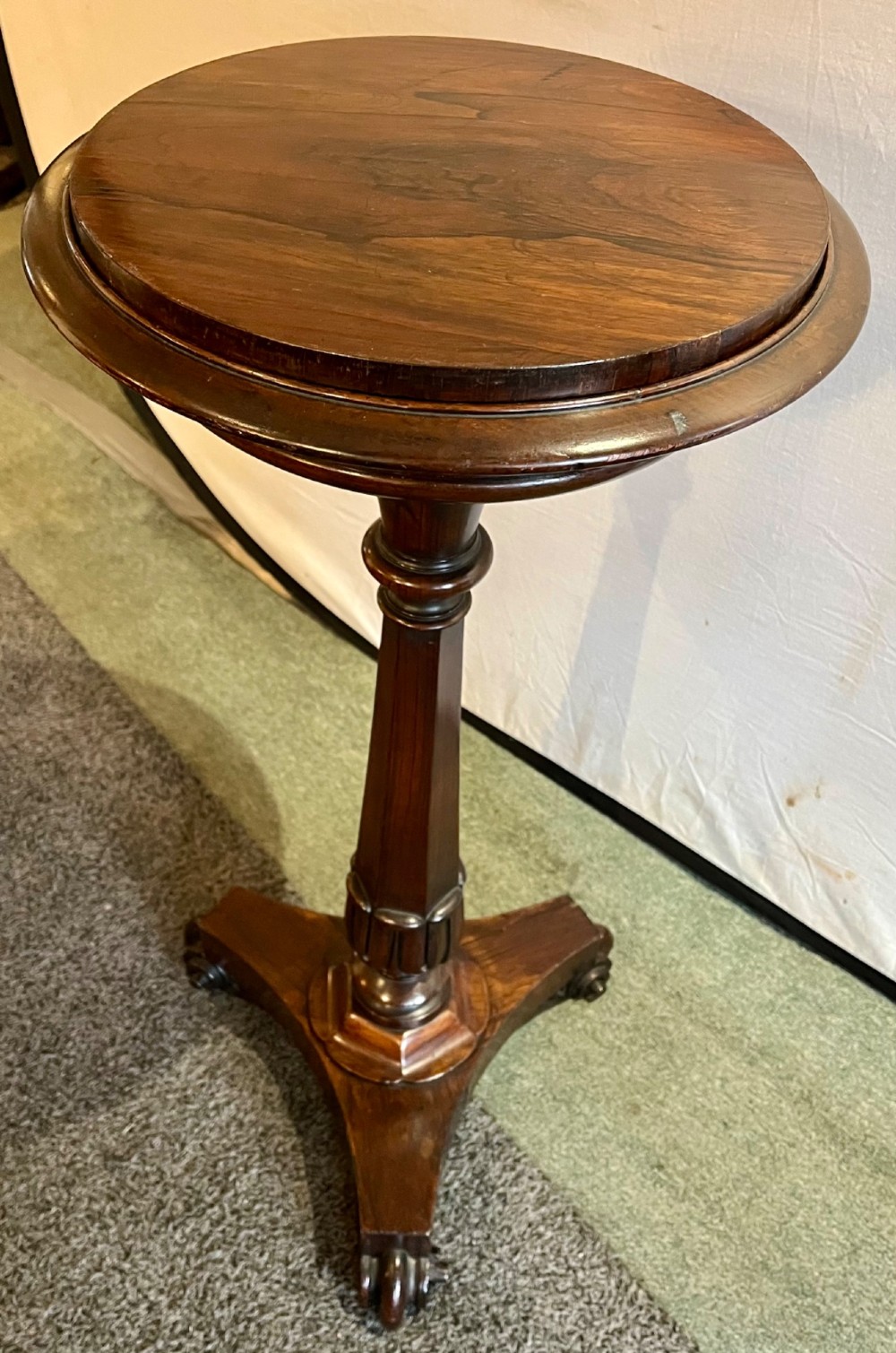 An early 19th-century rosewood wine table featuring a circular top, a tapered column, and a triform base with carved feet. View IV