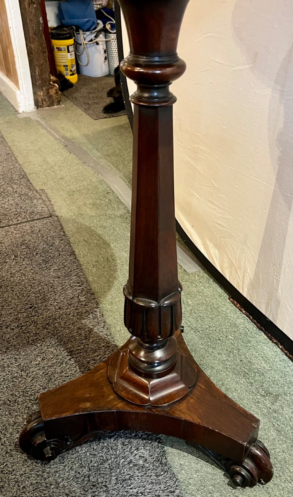 An early 19th-century rosewood wine table featuring a circular top, a tapered column, and a triform base with carved feet. View V