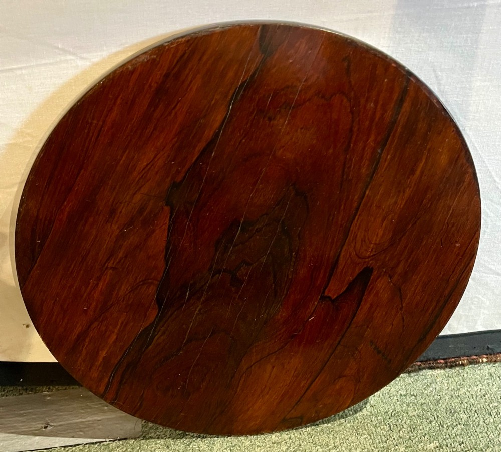 An early 19th-century rosewood wine table featuring a circular top, a tapered column, and a triform base with carved feet. View VIII