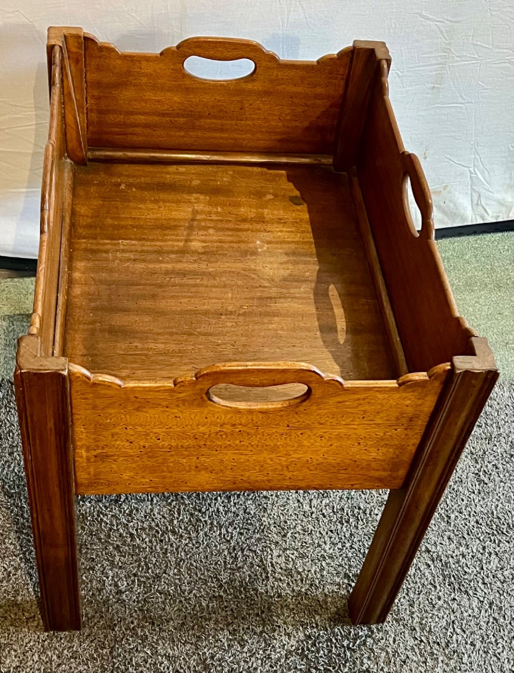 An early 20th-century mahogany low table featuring a raised gallery rim with integrated hand-holds and reeded square legs. View V