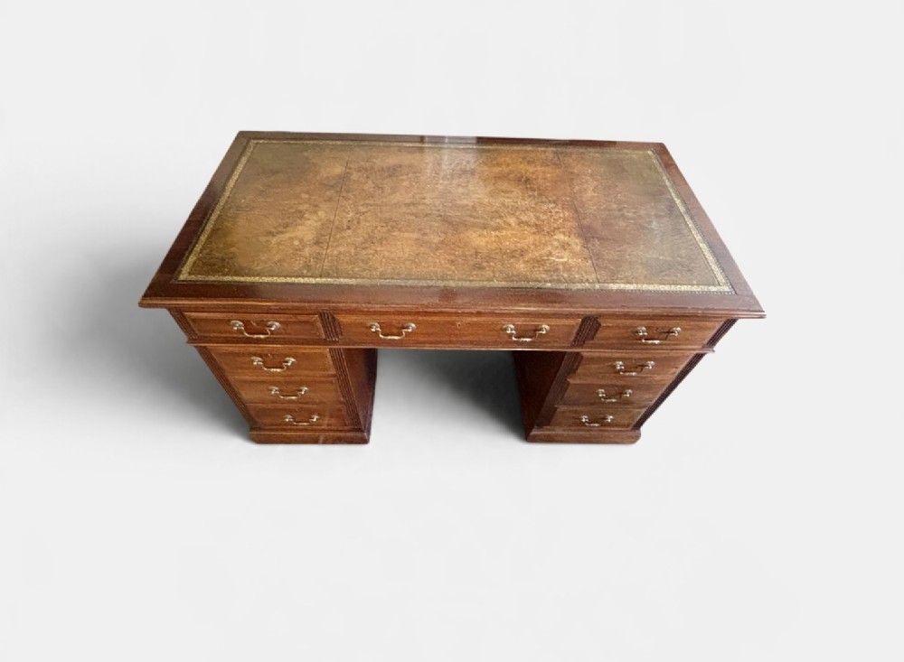 A Victorian mahogany pedestal desk featuring nine drawers with brass swan-neck handles and fluted side columns. View IV