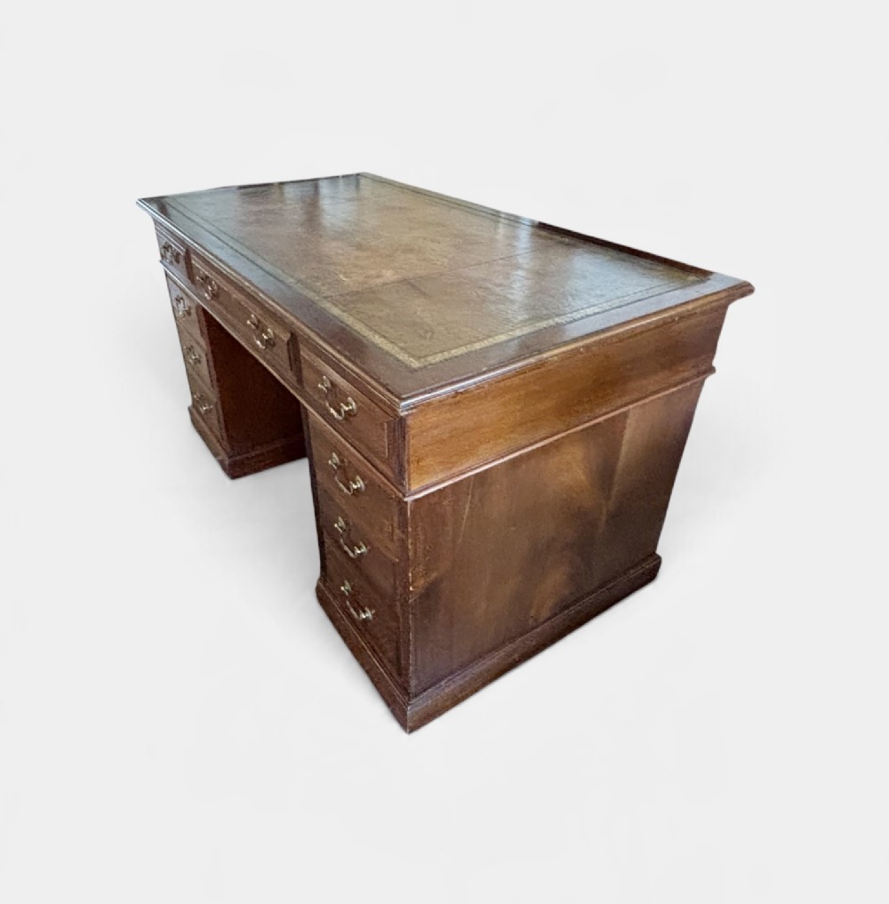 A Victorian mahogany pedestal desk featuring nine drawers with brass swan-neck handles and fluted side columns. View V