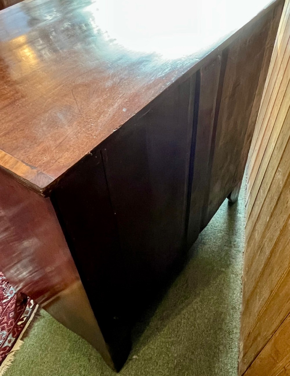 A Regency mahogany bowfront chest featuring three graduated drawers with crossbanded top inlay and brass ring handles. View VIII