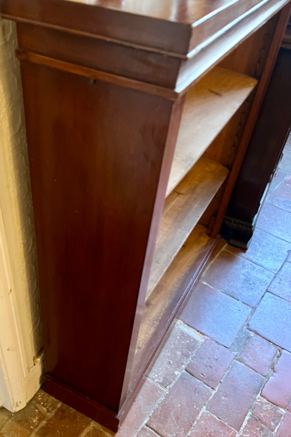 A Victorian open mahogany bookcase featuring three open timber shelves, a simple moulded top, and a plinth base. View V